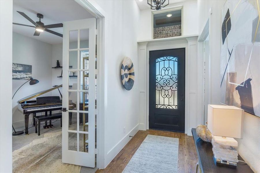 Foyer entrance with ceiling fan and dark hardwood / wood-style flooring