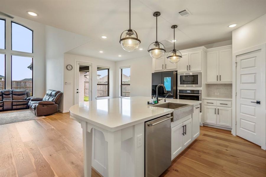 This kitchen conveniently connects to the breakfast area and living room for easy entertaining! The extra-large kitchen island is perfect for conversation or that much needed space to lay out your party spread for everyone to enjoy!