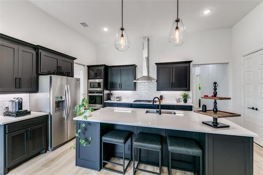 Kitchen featuring a center island, light hardwood / wood-style flooring, appliances with stainless steel finishes