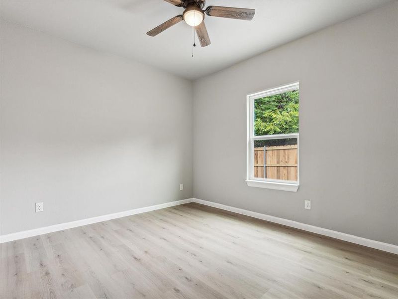 Unfurnished room featuring ceiling fan and light hardwood / wood-style flooring