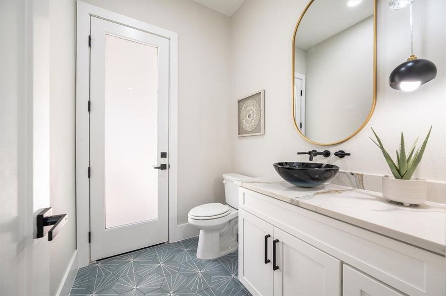 Bathroom featuring tile patterned flooring, toilet, and vanity