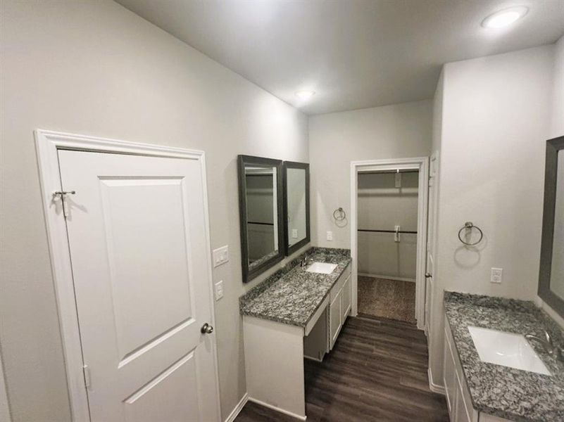 Separate vanities with granite counters & framed mirrors. Hers has convenient knee space!