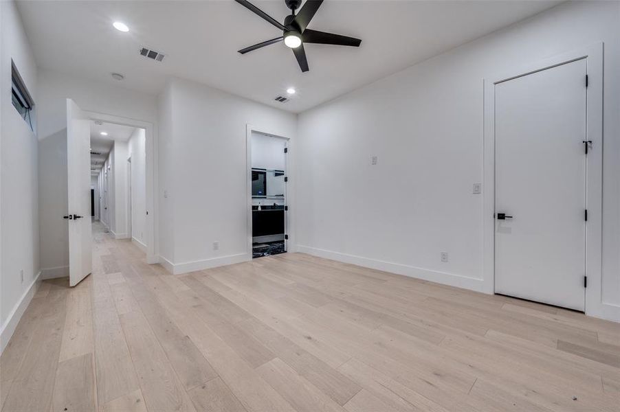 Unfurnished living room featuring light hardwood / wood-style floors and ceiling fan