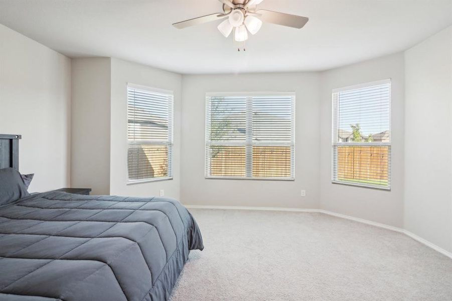 Primary bedroom with large windows