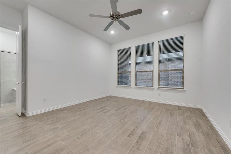 Spare room with ceiling fan and light wood-type flooring