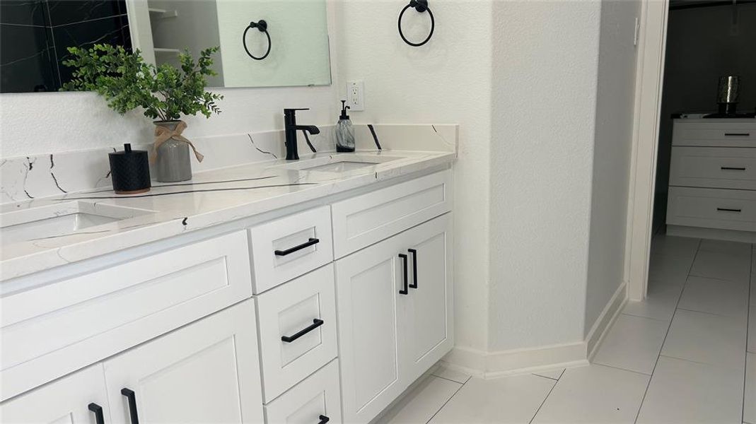 Bathroom featuring double vanity and tile patterned flooring