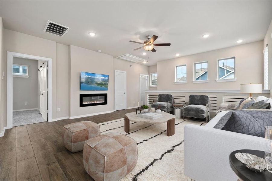Gather the family and guests together in your lovely living room! Featuring recessed lighting, dark stained ceiling fan, neutral paint, gorgeous wood floors and large windows that provide plenty of natural lighting throughout the day.
