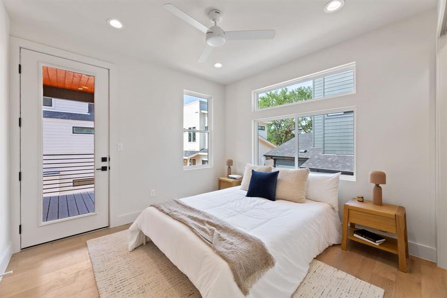 Primary bedroom with balcony entrance.