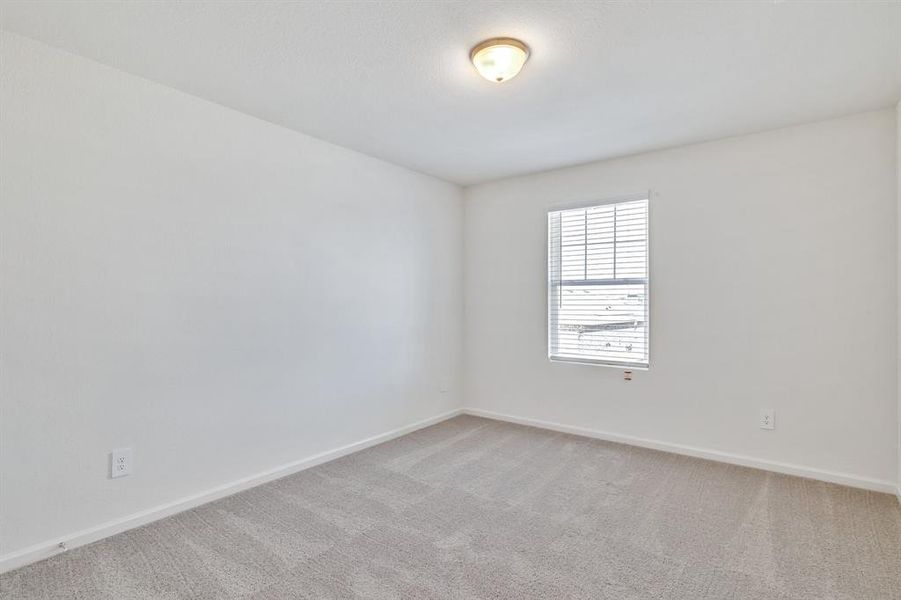 Unfurnished room featuring light colored carpet