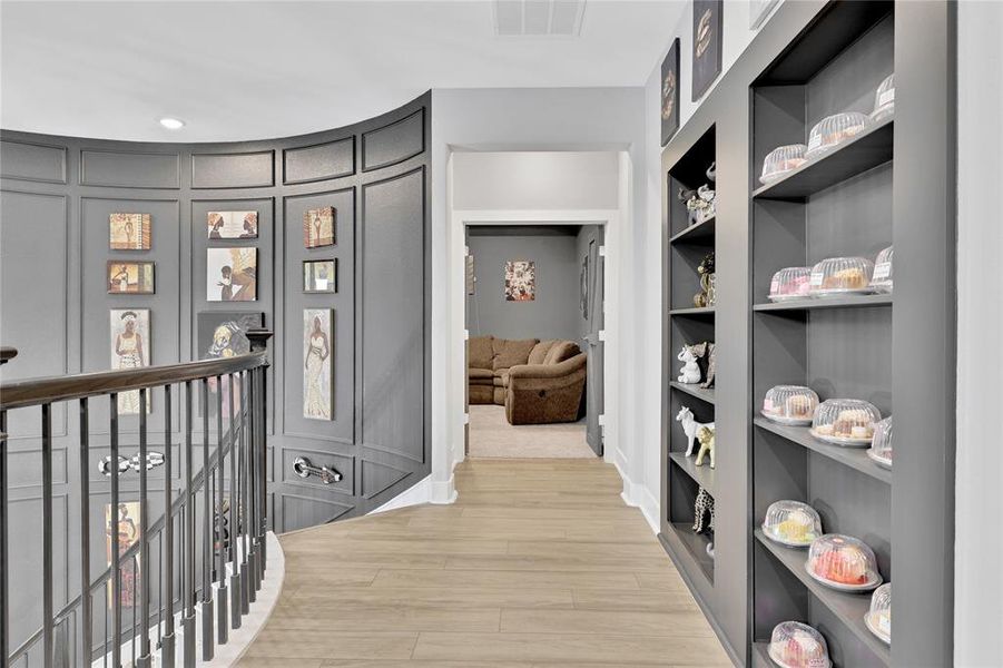 Curved Staircase with Wainscoting Paneling