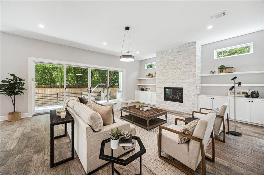 The Great Room with mock gas log fireplace and rear loggia access through grand sized sliding patio doors