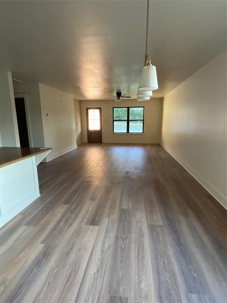 Unfurnished living room with hardwood / wood-style flooring and ceiling fan