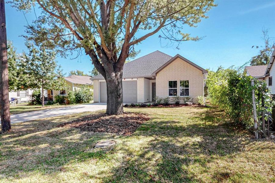 Ranch-style house with a front yard and a garage