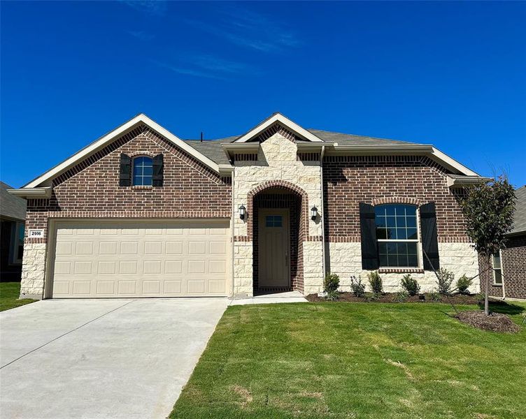 View of front of home with a front lawn and a garage