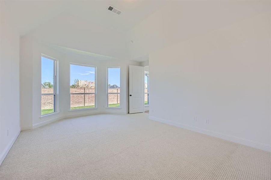 Empty room with light colored carpet