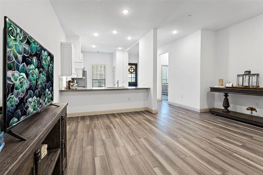 Unfurnished living room with light wood-type flooring and sink