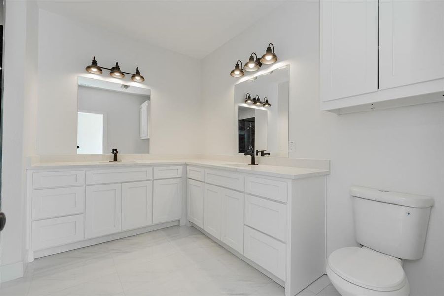 Bathroom featuring vanity and toilet