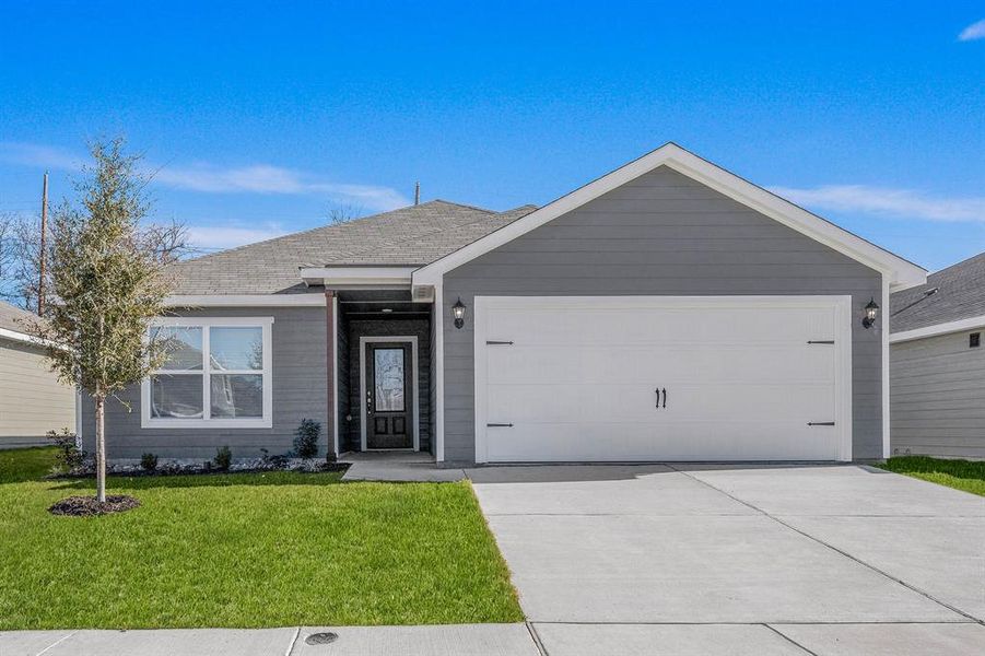 Ranch-style home featuring a garage and a front yard