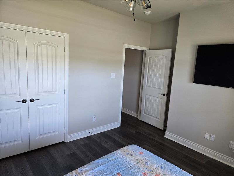 Unfurnished bedroom with a closet and dark hardwood / wood-style flooring