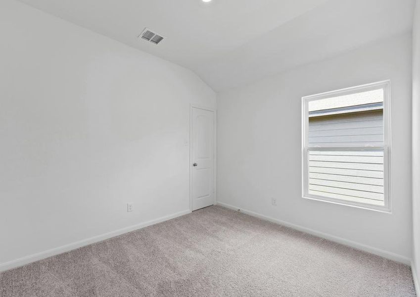 Bedroom with a large window providing natural light