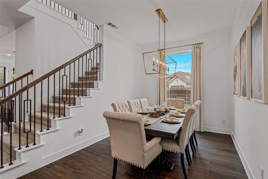 Dining area with dark hardwood / wood-style floors and a chandelier