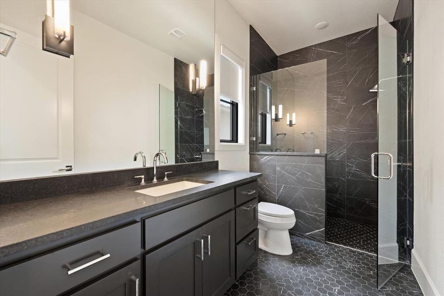 Bathroom with vanity, an enclosed shower, tile patterned flooring, tile walls, and toilet