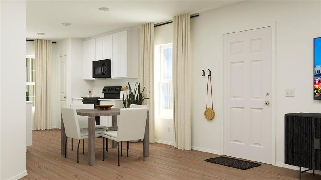 Dining area with a healthy amount of sunlight and light hardwood / wood-style floors