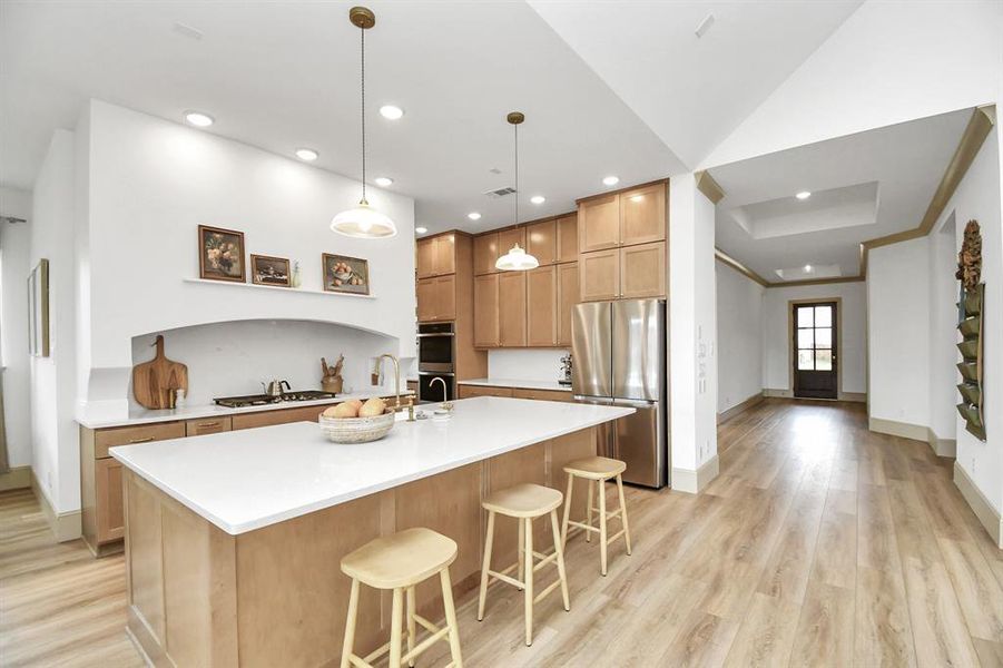 The custom range hood above the gas cook top provides a sleek style to the space.