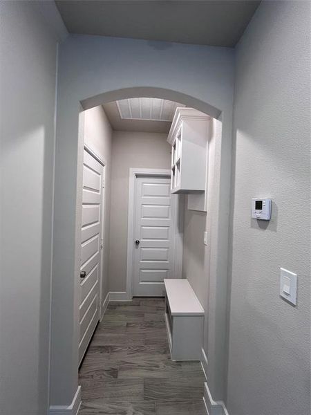 Hallway with dark hardwood / wood-style flooring