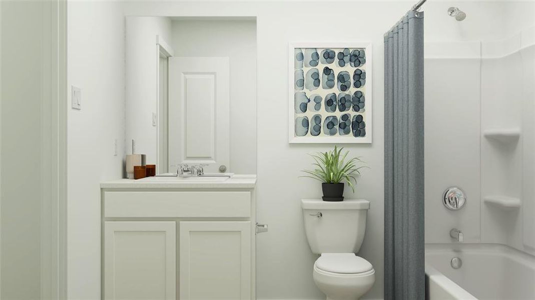 Full bathroom featuring vanity, shower / tub combo, and toilet