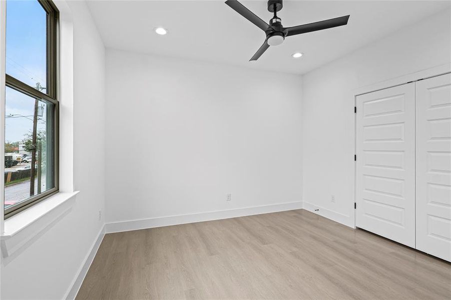 Unfurnished bedroom featuring ceiling fan, a closet, and light hardwood / wood-style flooring