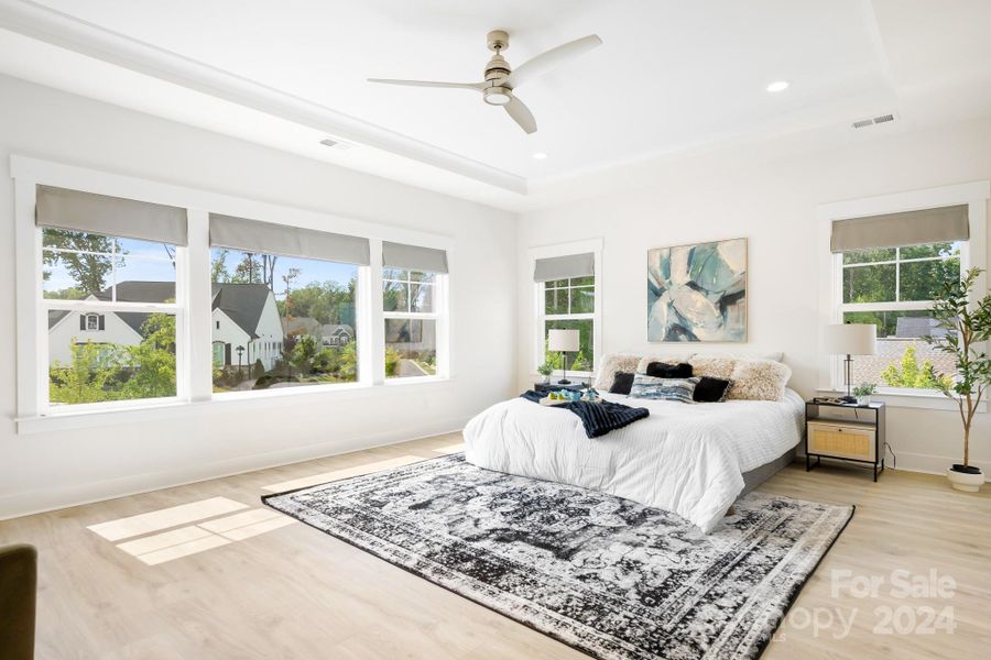 Large primary bedroom with 5 windows that bring in tons of natural light.