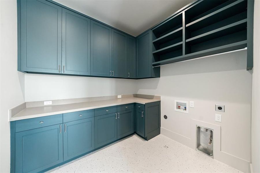 Utility room with custom cabinets and space for full-size appliances.