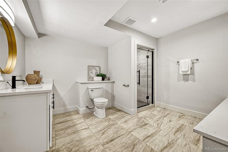 A bathroom completed the basement and offers tile flooring, a single vanity with plenty of cabinetry and a spacious shower!