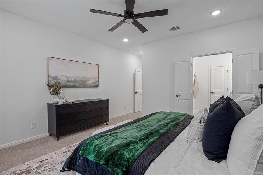 Carpeted bedroom with ceiling fan