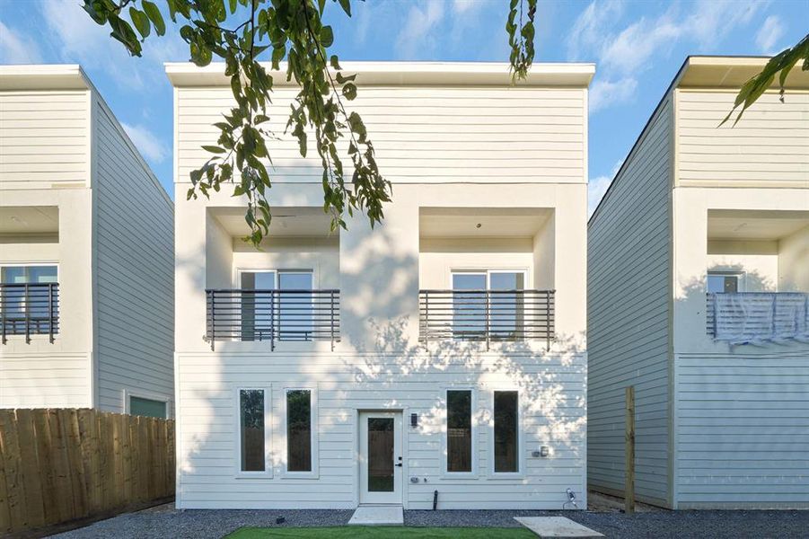 Each bedroom has an outdoor balcony overlooking the backyard.