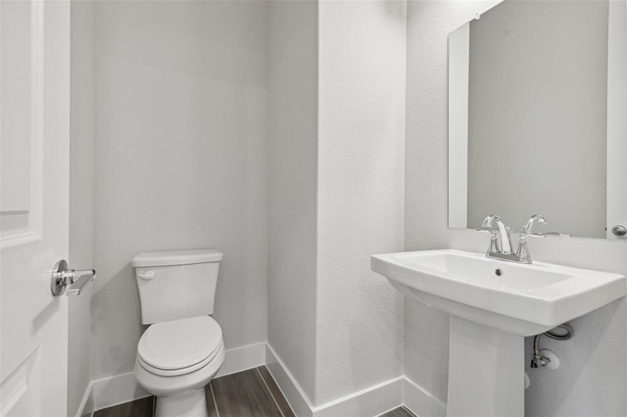 Bathroom with hardwood / wood-style floors and toilet