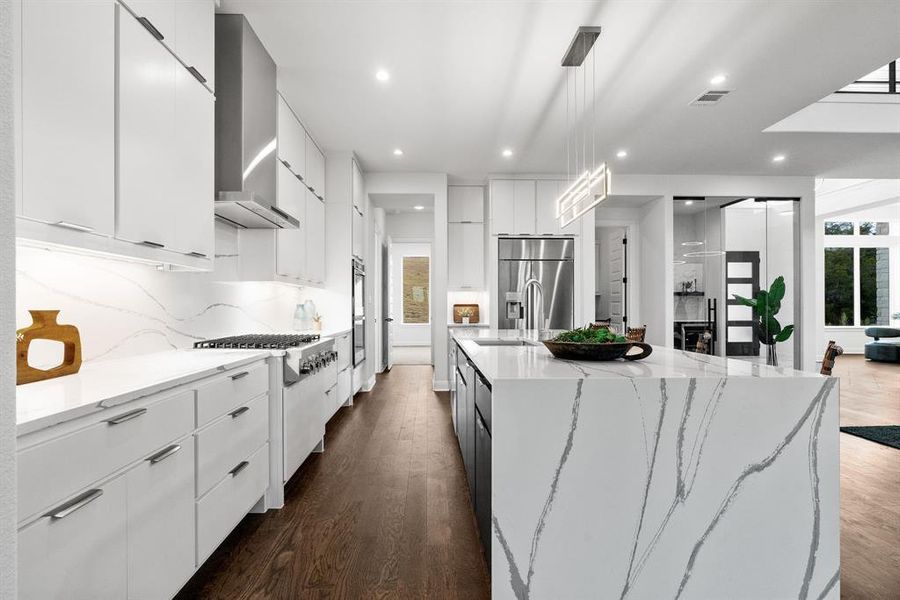 Stainless steel appliances, custom lighting and and oversized butlers pantry