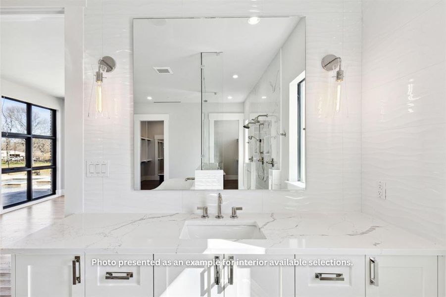 Bathroom featuring tile walls, a shower with shower door, tasteful backsplash, and vanity