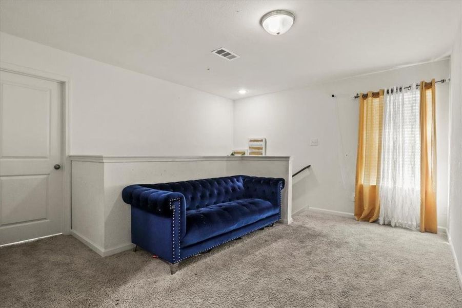 Sitting room with carpet flooring