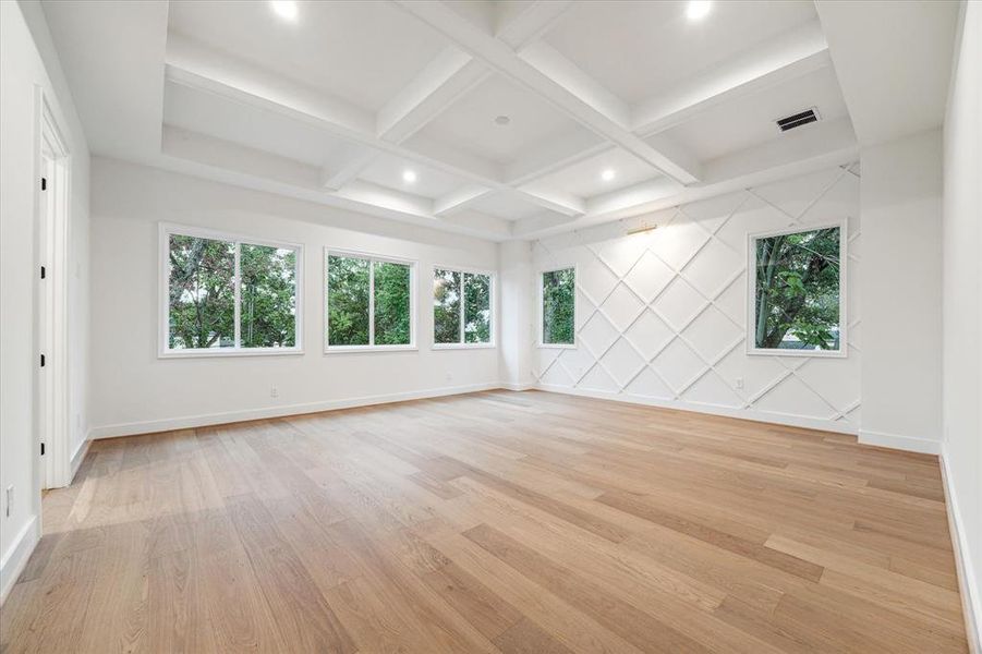 Enormous primary suite with boxtray ceiling - numerous windows give you a view from the treetops