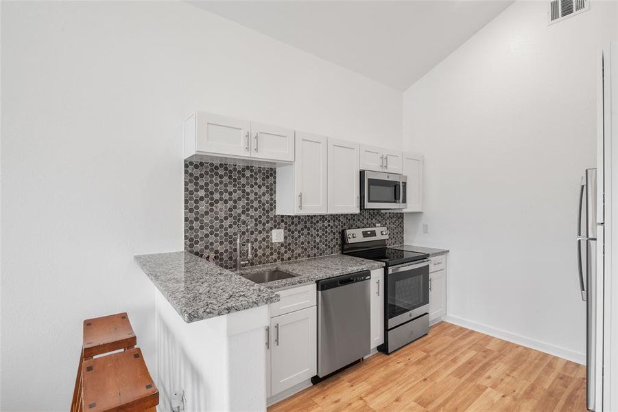 Another photo of the modern kitchen, features a bright, clean aesthetic.