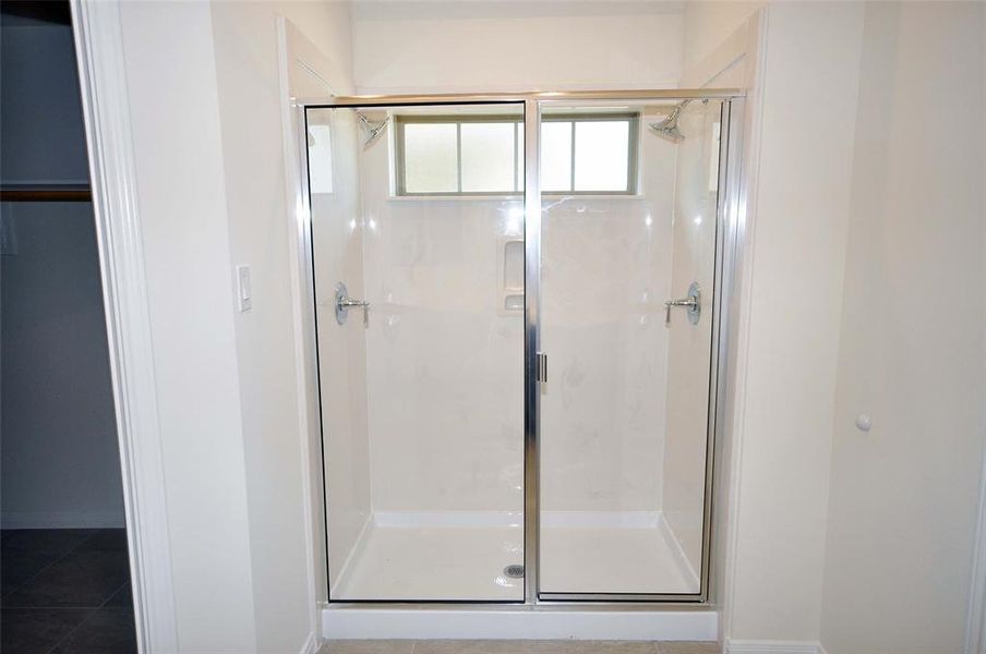 Relax in this  oversized shower with dual shower heads after a long day.