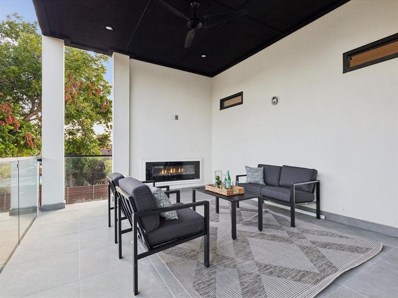 Upstairs patio / terrace with an outdoor living space with a fireplace