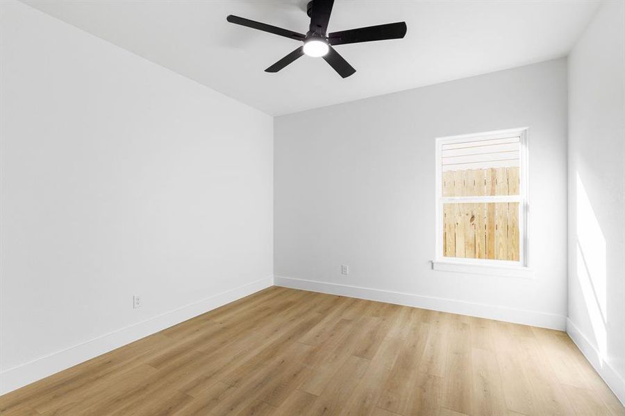 Spare room with light hardwood / wood-style floors and ceiling fan