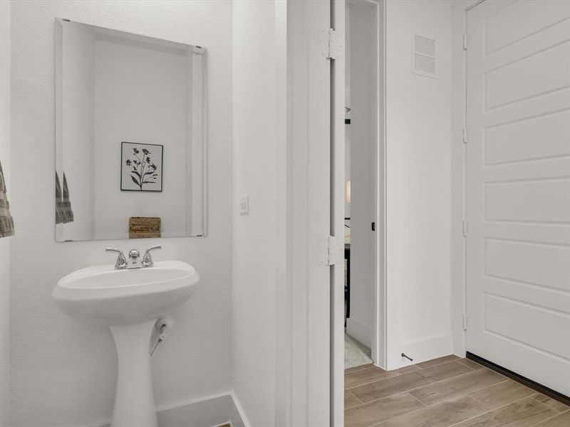 Downstairs half bath off the kitchen for guests.