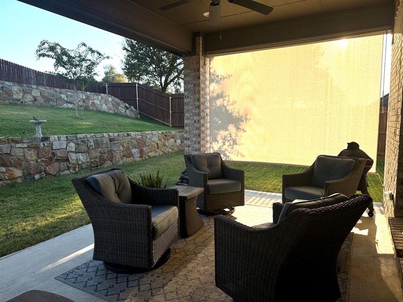 View of patio with ceiling fan & sunshades