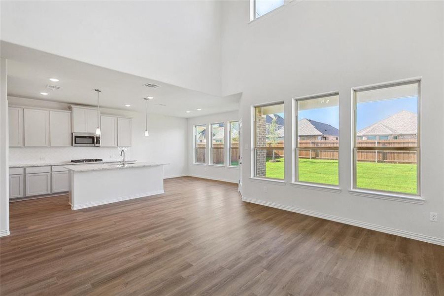 Unfurnished living room with a healthy amount of sunlight and hardwood / wood-style floors