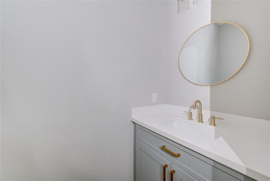 Half bath located between the kitchen and laundry room