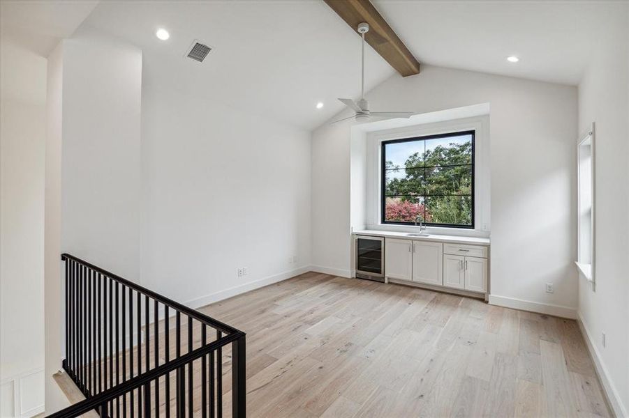 Upstairs game room / den with wetbar and beverage refrigerator.